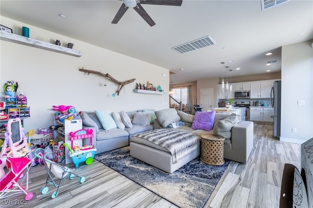 living area with ceiling fan, light wood-style flooring, visible vents, and recessed lighting