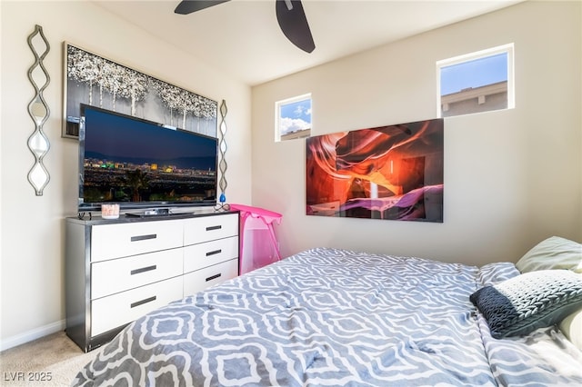 carpeted bedroom featuring a ceiling fan and baseboards