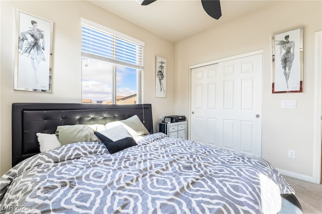 bedroom with a ceiling fan, carpet, baseboards, and a closet