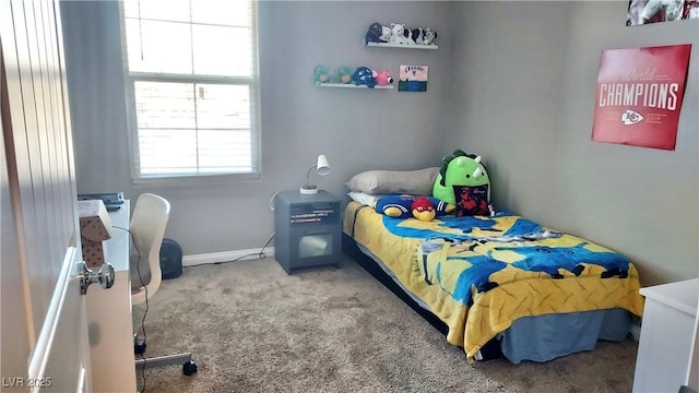 carpeted bedroom featuring baseboards