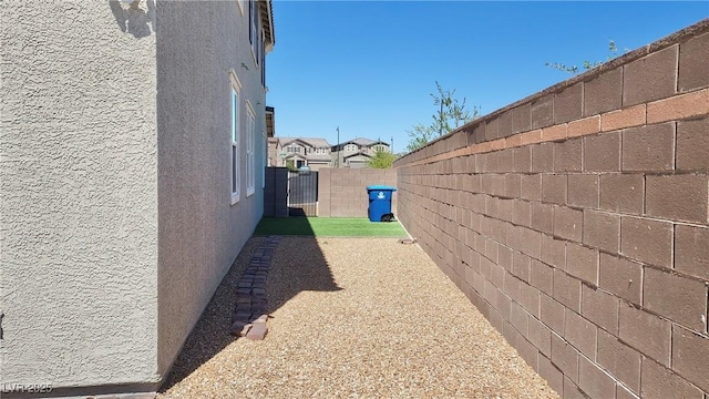 view of property exterior featuring a fenced backyard and stucco siding