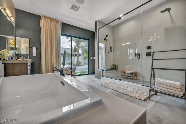 bathroom featuring a tub, a shower stall, visible vents, and vanity