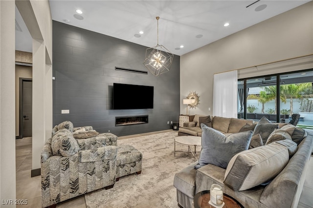 living room with tile patterned flooring, recessed lighting, a large fireplace, an accent wall, and a notable chandelier