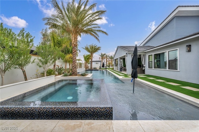 outdoor pool with a fenced backyard and a patio