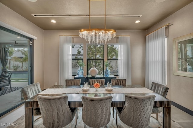 dining space with plenty of natural light, a notable chandelier, a textured ceiling, and recessed lighting