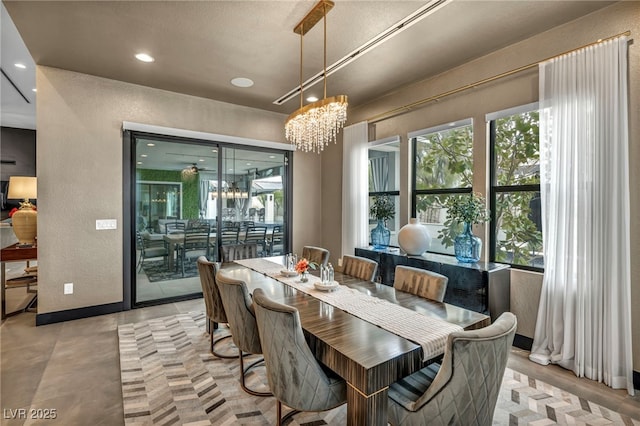 dining room featuring recessed lighting, baseboards, a notable chandelier, and a textured wall