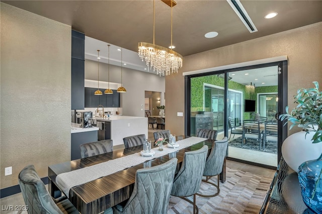 dining room featuring recessed lighting, a textured wall, and an inviting chandelier