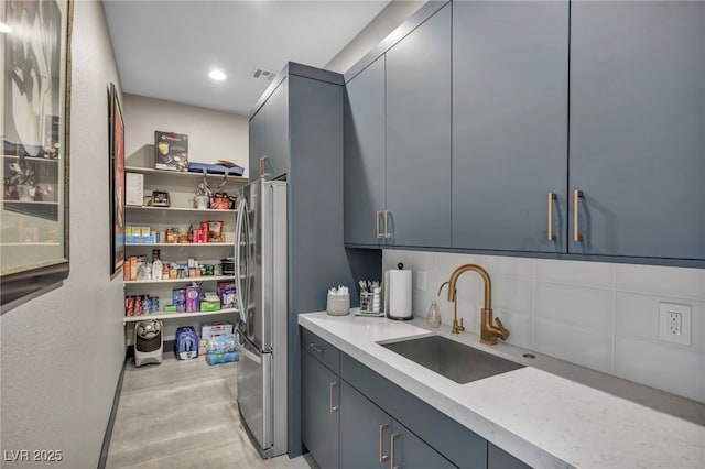 interior space with laundry area, a sink, visible vents, and recessed lighting