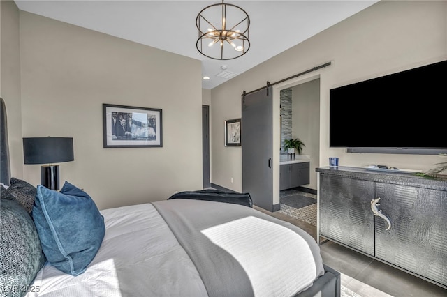 bedroom with recessed lighting, a notable chandelier, ensuite bath, and a barn door