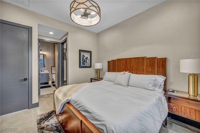 bedroom featuring ensuite bathroom and recessed lighting