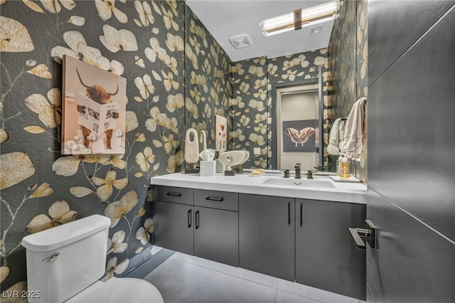 bathroom featuring visible vents, vanity, toilet, and wallpapered walls