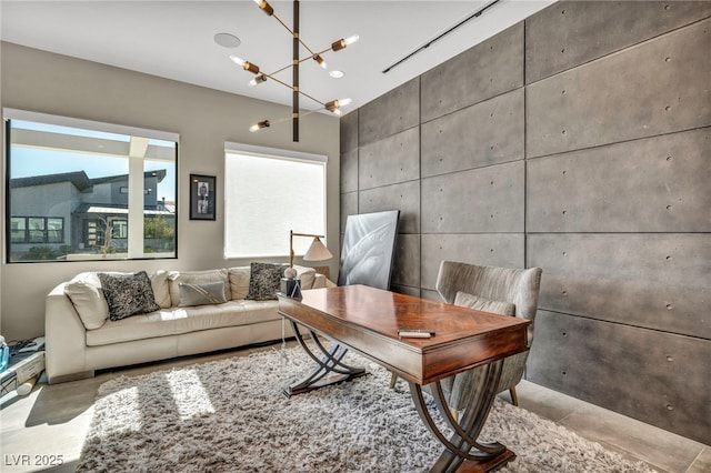 office with a chandelier and concrete flooring