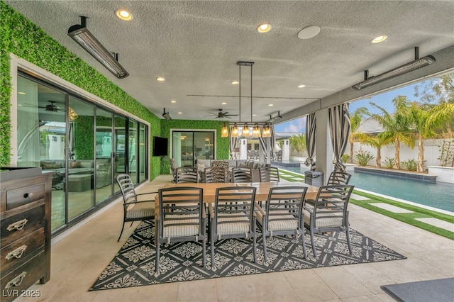 sunroom / solarium featuring a ceiling fan