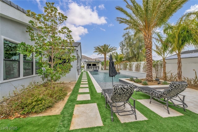 view of property's community with a pool, a patio area, fence, and a lawn