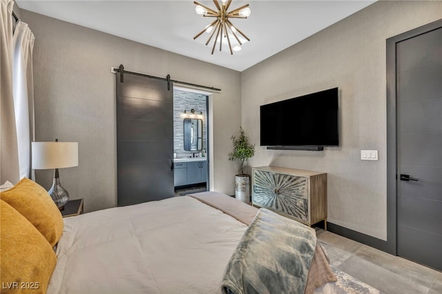 bedroom with a chandelier, ensuite bath, and a barn door