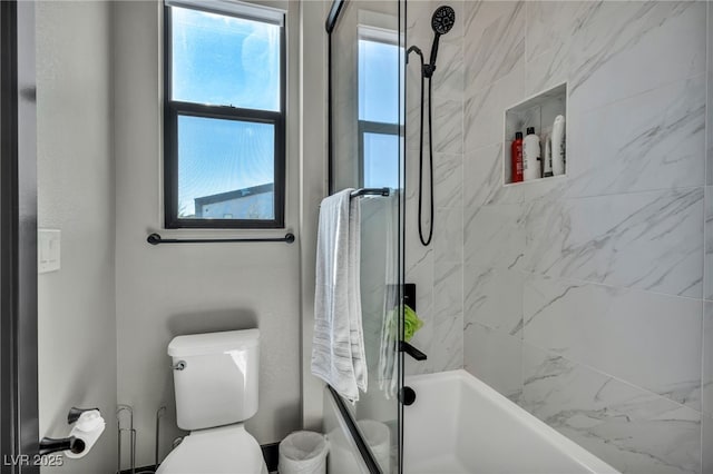 bathroom with shower / bathtub combination and toilet