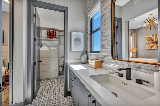 bathroom with backsplash, vanity, and tile patterned floors