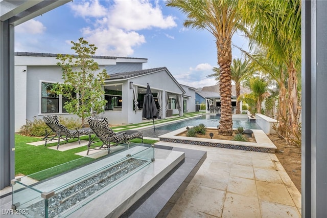 view of property's community with a pool, a patio area, and a lawn