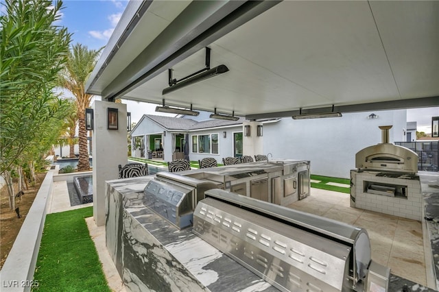 view of patio featuring area for grilling and outdoor wet bar