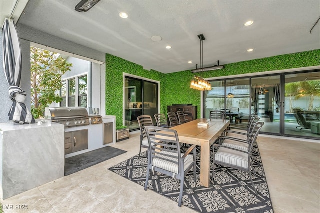 view of patio featuring an outdoor kitchen, outdoor dining area, and area for grilling