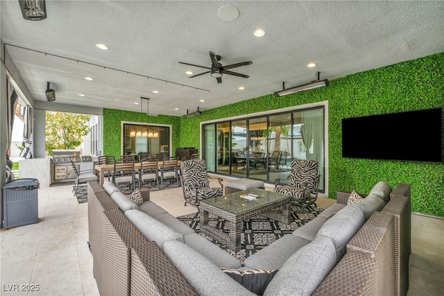 view of patio featuring outdoor dining area, a ceiling fan, an outdoor living space, and exterior kitchen