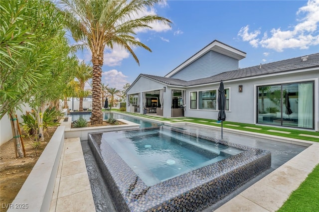 view of swimming pool with a patio area and a pool with connected hot tub