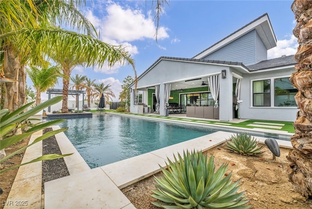 outdoor pool with a patio area and a ceiling fan