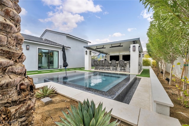 back of house featuring fence, outdoor dry bar, and stucco siding