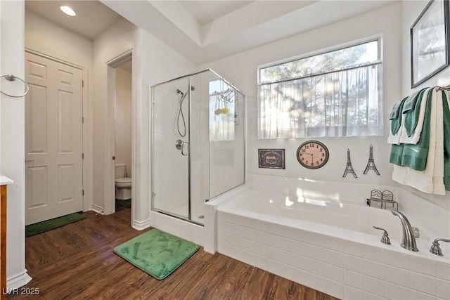 full bath with toilet, vanity, a shower stall, wood finished floors, and a bath