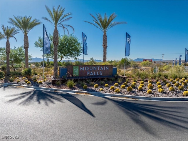 community / neighborhood sign with a mountain view