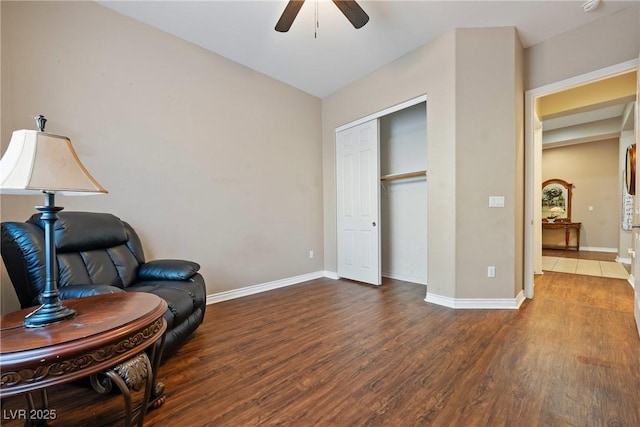 sitting room with ceiling fan, wood finished floors, and baseboards