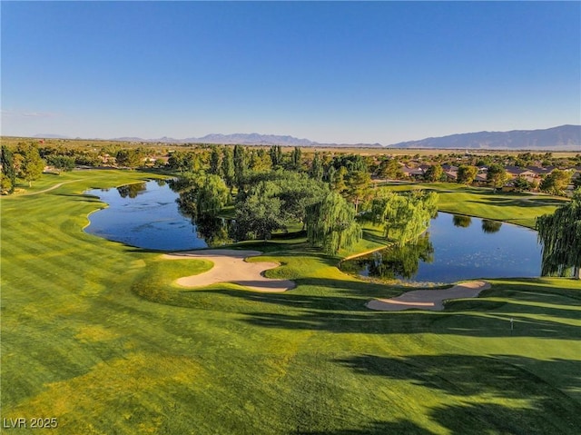 surrounding community with view of golf course, a lawn, and a water and mountain view