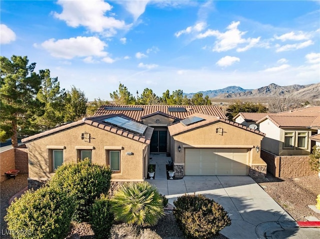 mediterranean / spanish-style house with a garage, driveway, a tile roof, and stucco siding