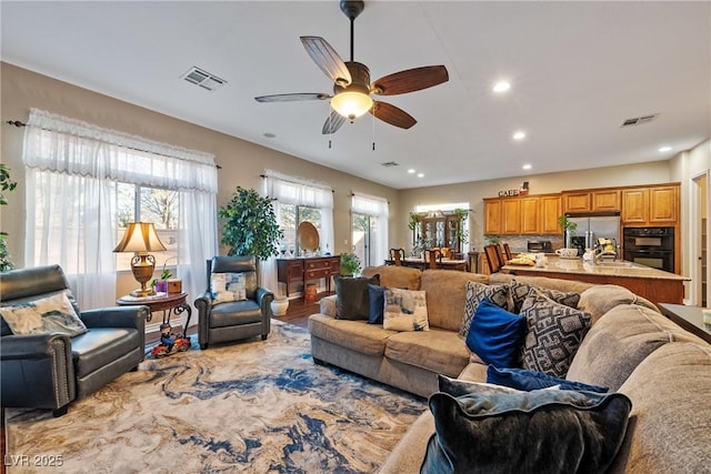 living room with recessed lighting, visible vents, and ceiling fan