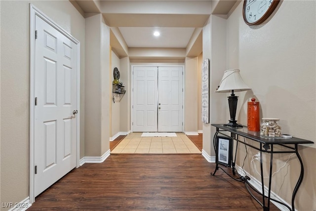 entrance foyer featuring baseboards and wood finished floors