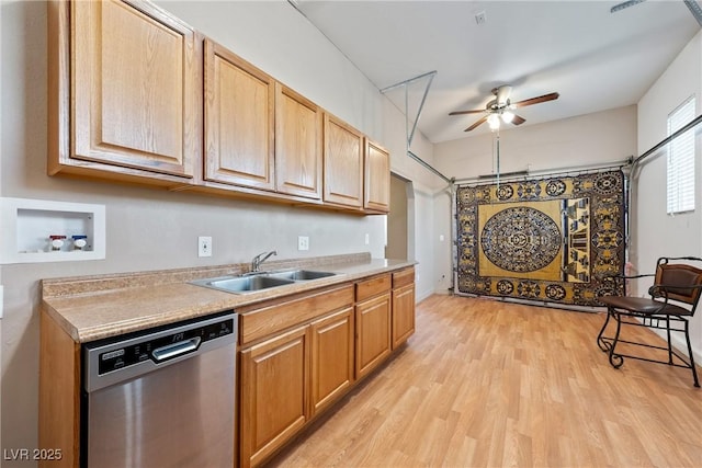 kitchen featuring a ceiling fan, light countertops, light wood-type flooring, stainless steel dishwasher, and a sink