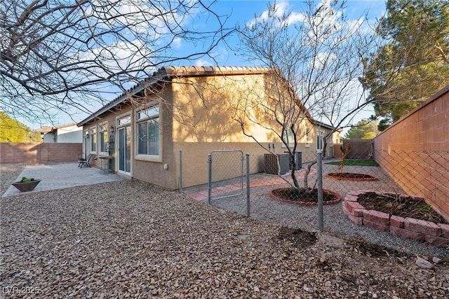 view of property exterior with a fenced backyard, a patio, and stucco siding