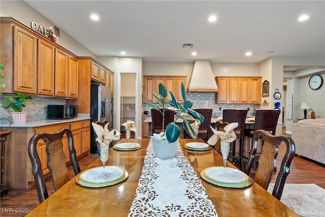 dining space featuring wood finished floors, visible vents, and recessed lighting