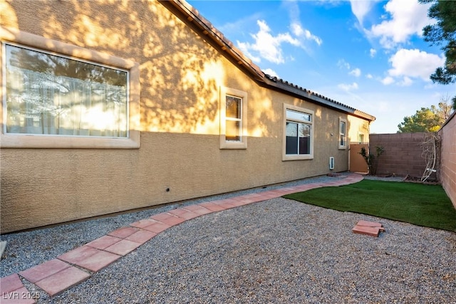 rear view of house with a patio area, a fenced backyard, stucco siding, and a tiled roof