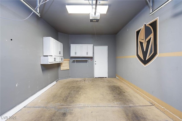 garage with a garage door opener and baseboards