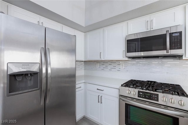 kitchen featuring stainless steel appliances, light countertops, backsplash, and white cabinetry