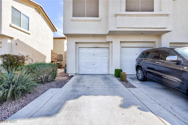 garage featuring concrete driveway