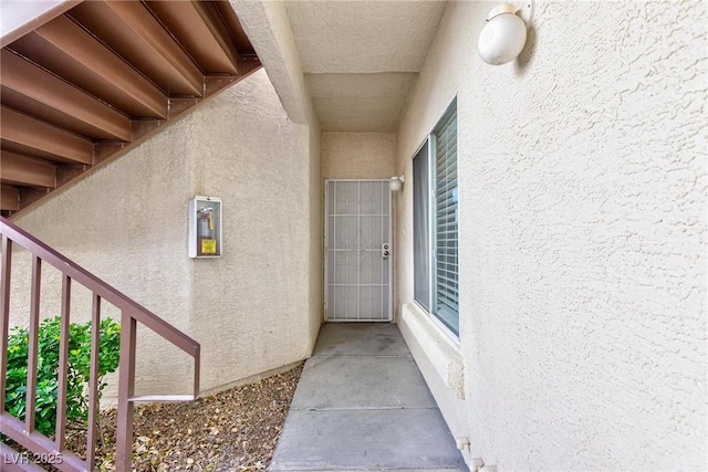 property entrance with stucco siding