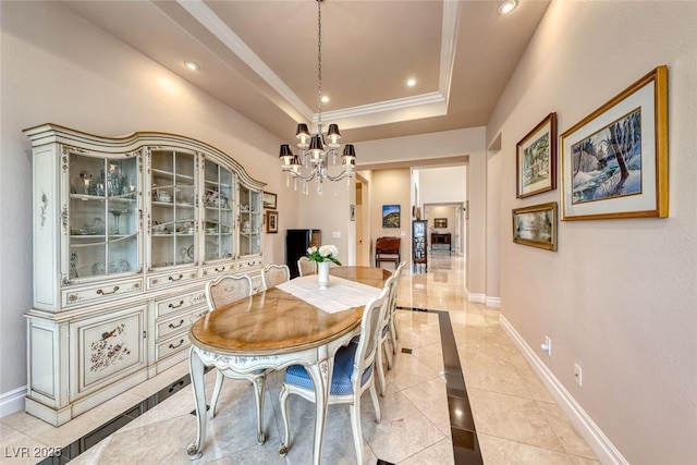 dining room featuring crown molding, a tray ceiling, recessed lighting, and baseboards