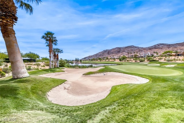 surrounding community with view of golf course and a water and mountain view