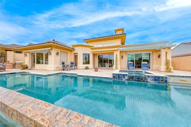 rear view of property featuring a patio area, a chimney, an outdoor kitchen, and stucco siding