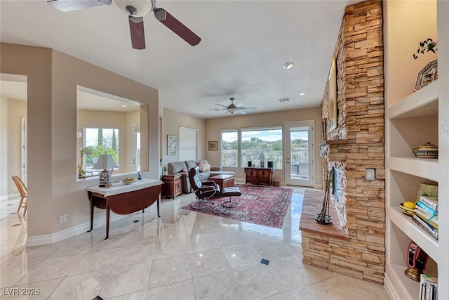 living room with visible vents, recessed lighting, a ceiling fan, and baseboards