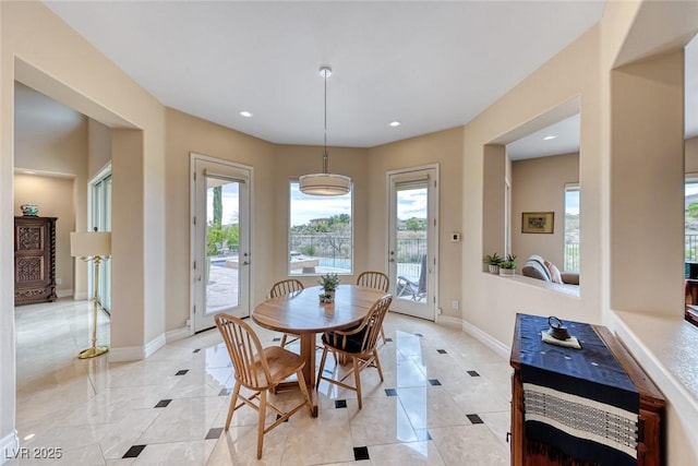 dining area with a wealth of natural light, light tile patterned floors, baseboards, and recessed lighting