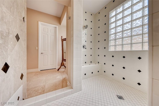 full bath with a tile shower and tile patterned floors