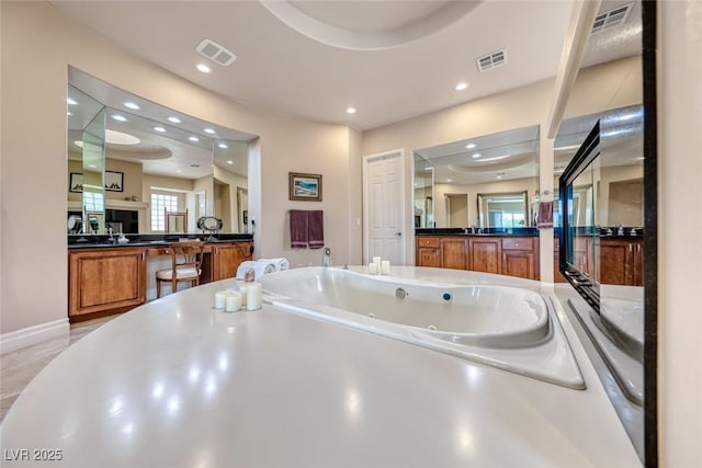 full bathroom with a jetted tub, visible vents, and recessed lighting